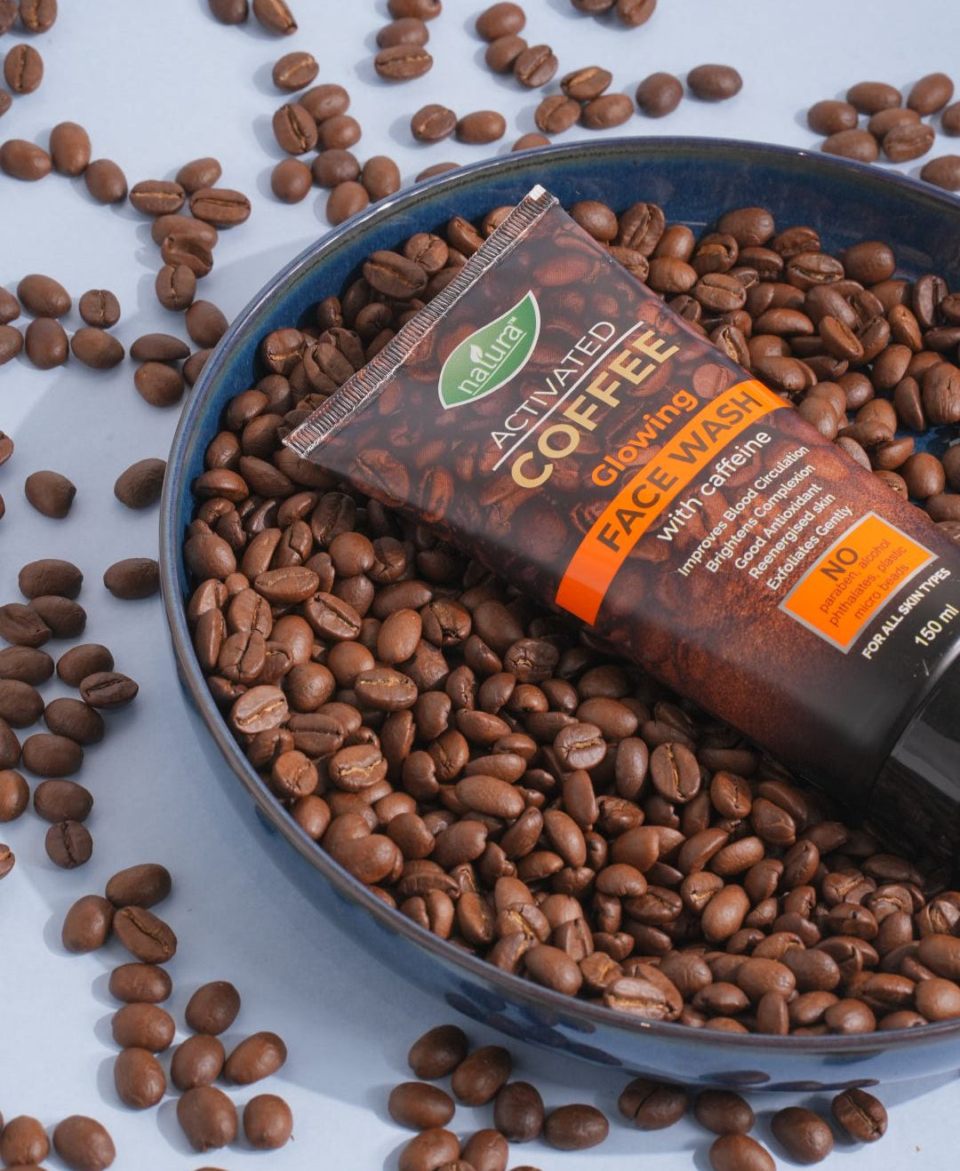 Activated coffee face wash with coffee beans on a white background