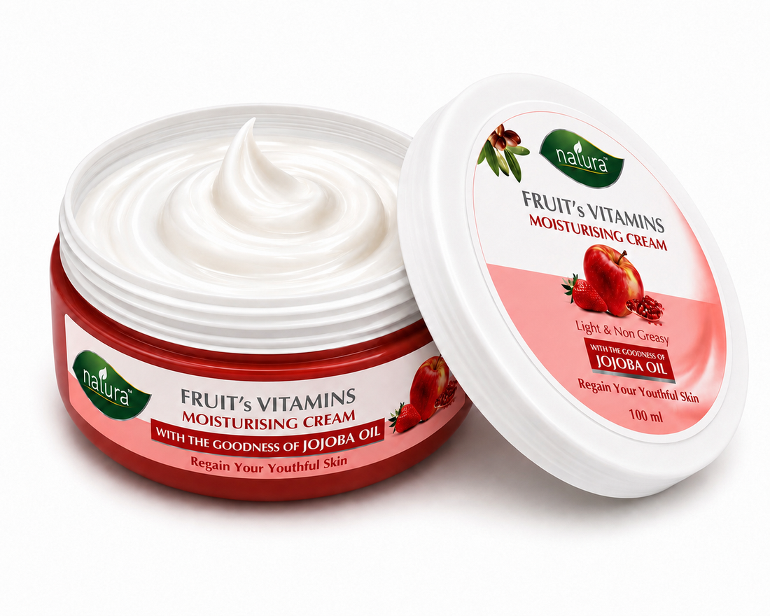 A jar of natura Fruit's Vitamins Moisturising Cream with its lid leaning against it on a white background. The jar is red with white cream visible inside, and the lid features a pink and white label with illustrations of strawberries and pomegranate.